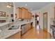 Modern kitchen showcasing granite countertops, stainless steel appliances, and hardwood floors at 100 Watkins Farm Rd, Rolesville, NC 27571