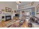 Charming living room with a cozy fireplace, hardwood floors, and comfortable seating area at 100 Watkins Farm Rd, Rolesville, NC 27571