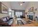 Spacious living room with vaulted ceilings, hardwood floors, fireplace, and comfortable leather seating at 100 Watkins Farm Rd, Rolesville, NC 27571