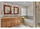 The main bath includes a double vanity, garden tub and a window with decorative glass at 100 Watkins Farm Rd, Rolesville, NC 27571