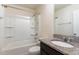 Bathroom including bath tub and shower combo, granite countertops, and dark cabinets at 1009 Laceflower Dr, Durham, NC 27713