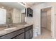 Bathroom featuring double sinks, granite countertops, modern fixtures, and a walk in closet at 1009 Laceflower Dr, Durham, NC 27713