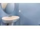Charming powder room with a pedestal sink and soft blue walls at 1009 Laceflower Dr, Durham, NC 27713