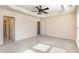 Spacious bedroom features a ceiling fan and neutral carpeting, creating a cozy and inviting atmosphere at 1009 Laceflower Dr, Durham, NC 27713