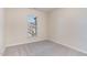 Bedroom featuring carpet, neutral wall color, and a window with a view at 1009 Laceflower Dr, Durham, NC 27713