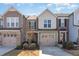 Charming townhouses featuring attached garages and neutral color palettes create an inviting curb appeal at 1009 Laceflower Dr, Durham, NC 27713