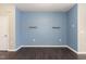 Versatile flex space with fresh blue paint, wood floors, and simple shelving at 1009 Laceflower Dr, Durham, NC 27713