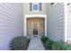 Inviting front entrance with a stone facade and neatly landscaped shrubs at 1009 Laceflower Dr, Durham, NC 27713