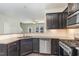Kitchen with stainless steel appliances, granite countertops, and dark cabinetry at 1009 Laceflower Dr, Durham, NC 27713