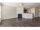 Living room with hardwood floors, fireplace, and open view of the kitchen at 1009 Laceflower Dr, Durham, NC 27713