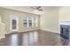 Bright living room with a fireplace, hardwood floors, and large windows at 1009 Laceflower Dr, Durham, NC 27713