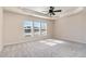 Bright main bedroom with large windows, trey ceilings, and plush carpeting at 1009 Laceflower Dr, Durham, NC 27713