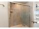 Tiled shower area featuring a glass door and modern shower head fixture at 1009 Laceflower Dr, Durham, NC 27713