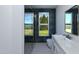 Bright bathroom featuring a walk-in shower, modern vanity, and a window with view to the outdoors at 105 Sherwood Ln, Hillsborough, NC 27278