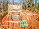 Framing underway for a two-story home with lumber and zip system boards visible at 105 Sherwood Ln, Hillsborough, NC 27278