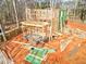 Framing underway for a two-story home with lumber and zip system boards visible from aerial view at 105 Sherwood Ln, Hillsborough, NC 27278