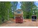 Two-story home with a charming front porch and light yellow exterior paint with dumpster at 105 Sherwood Ln, Hillsborough, NC 27278