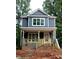 Charming two-story home featuring a welcoming front porch, neutral exterior paint, and beautiful new windows at 105 Sherwood Ln, Hillsborough, NC 27278