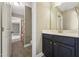 Well-lit bathroom featuring a black vanity, shower with polka-dot curtain and tiled floors at 109 Hammermill Dr, Fuquay Varina, NC 27526