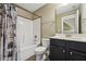 Bathroom with a shower/tub combo, toilet, black vanity and sink at 109 Hammermill Dr, Fuquay Varina, NC 27526