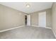 Large bedroom featuring neutral carpet, multiple doors, and abundant space at 109 Hammermill Dr, Fuquay Varina, NC 27526