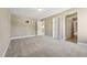 Large bedroom featuring neutral carpet, multiple doors, and abundant space at 109 Hammermill Dr, Fuquay Varina, NC 27526
