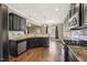Modern kitchen with stainless steel appliances, granite countertops, dark cabinets, and an open layout at 109 Hammermill Dr, Fuquay Varina, NC 27526