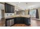 Kitchen featuring stainless steel appliances, granite countertops, dark cabinets, and hardwood flooring at 109 Hammermill Dr, Fuquay Varina, NC 27526
