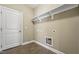 Functional laundry room with utility sink, tile floors and ample shelving for storage at 109 Hammermill Dr, Fuquay Varina, NC 27526