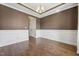 Living room with hardwood floors, crown molding, and wainscoting near a staircase and arched entryway at 109 Hammermill Dr, Fuquay Varina, NC 27526