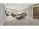 Staged living room with neutral walls, carpet, and bright natural light at 109 Hammermill Dr, Fuquay Varina, NC 27526