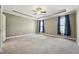 Spacious main bedroom features neutral walls, carpet, and a tray ceiling with a fan at 109 Hammermill Dr, Fuquay Varina, NC 27526