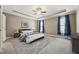 Comfortable main bedroom features tray ceiling, carpeted floors, natural light, and calming colors at 109 Hammermill Dr, Fuquay Varina, NC 27526