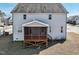 A view of the rear exterior of the house showcasing a screened porch and backyard at 109 Hammermill Dr, Fuquay Varina, NC 27526