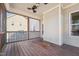This is the spacious screened porch featuring wood flooring, ceiling fan and serene outdoor views at 109 Hammermill Dr, Fuquay Varina, NC 27526