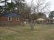 Fenced backyard with views of neighboring houses and mature trees at 110 N 8Th St, Erwin, NC 28339