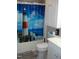 Bathroom with vanity, toilet and shower with lighthouse-themed curtain and overhead storage at 110 N 8Th St, Erwin, NC 28339