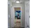Hallway view of a bathroom with blue and white shower curtain and tiled floor at 110 N 8Th St, Erwin, NC 28339