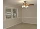 Bright bedroom with carpet flooring, a ceiling fan, and natural light from a window at 110 N 8Th St, Erwin, NC 28339