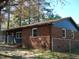 Exterior view of home with brick accents, wood siding, and fenced in yard at 110 N 8Th St, Erwin, NC 28339