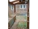 View from inside greenhouse with shelving and exposed window frames at 110 N 8Th St, Erwin, NC 28339