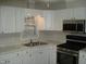 Kitchen featuring white cabinets, stainless steel appliances and white countertop at 110 N 8Th St, Erwin, NC 28339