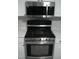 Stainless steel stove with microwave above and white cabinets and countertops at 110 N 8Th St, Erwin, NC 28339