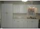 Kitchen with stainless steel sink, white cabinets and gray countertop at 110 N 8Th St, Erwin, NC 28339