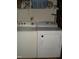 Laundry area featuring washer and dryer, with shelving at 110 N 8Th St, Erwin, NC 28339