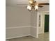 Neutral colored living room with a ceiling fan, chair rail and an open doorway at 110 N 8Th St, Erwin, NC 28339