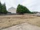 Fenced backyard with mature trees and lawn at 1113 Crendall Way, Wake Forest, NC 27587