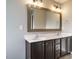 A modern bathroom with a double sink vanity, large mirror, and contemporary lighting at 1113 Crendall Way, Wake Forest, NC 27587