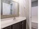 A modern bathroom featuring a single sink vanity with dark cabinets and light countertops at 1113 Crendall Way, Wake Forest, NC 27587