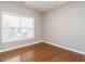 Bright bedroom with hardwood floors and a large window at 1113 Crendall Way, Wake Forest, NC 27587